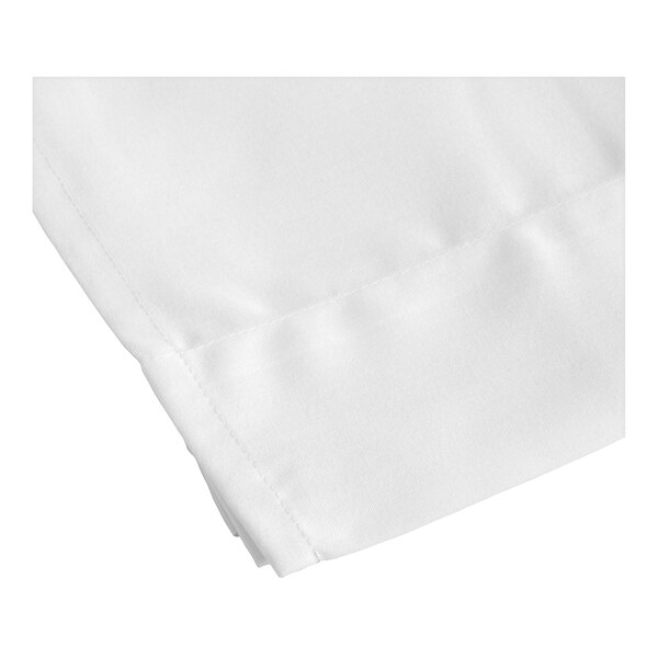 A close-up of a green floral 1888 Mills Beyond Impressions queen size top sheet with a folded edge.