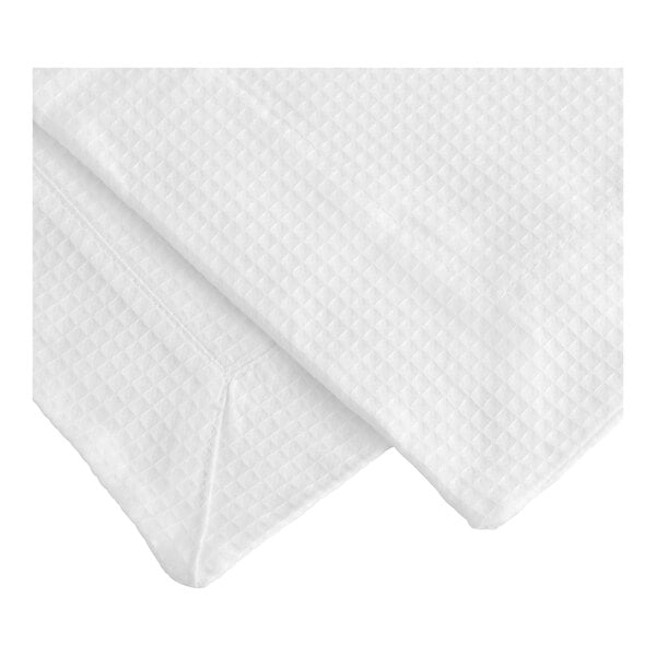 A white cloth bed scarf with a diamond pattern folded on a white surface.