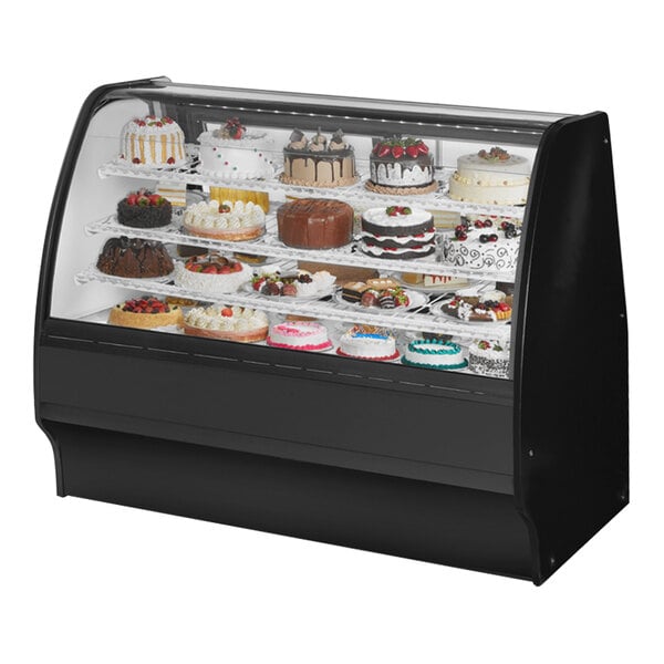 A True black refrigerated bakery display case with cakes inside.