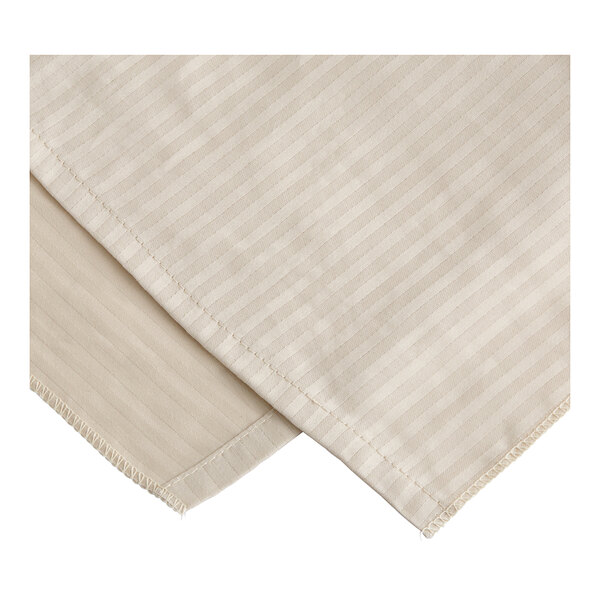 A close-up of a natural linen tone on tone striped bed skirt.