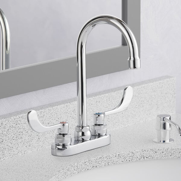 A white bathroom counter with an American Standard deck-mount faucet with wrist blade handles.