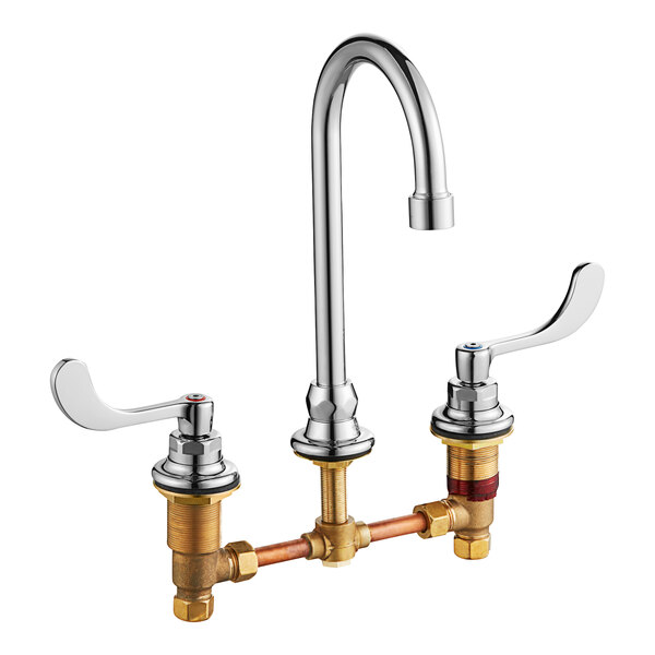 An American Standard deck-mount faucet with two brass wrist blade handles.