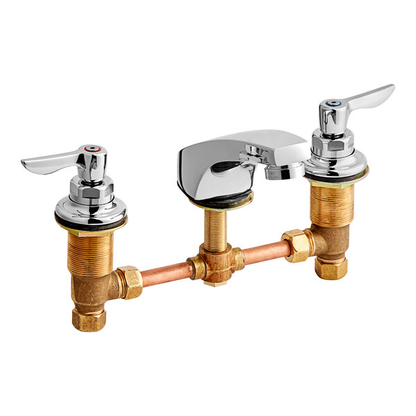 An American Standard deck-mount faucet with two brass lever handles and a brass spout.