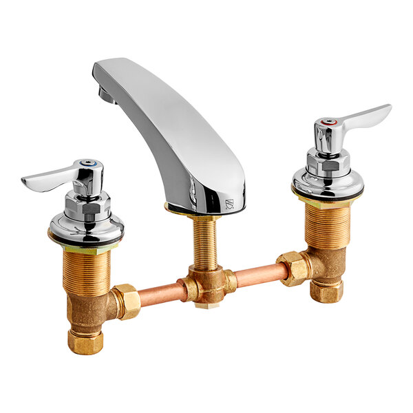 An American Standard deck-mount faucet with brass and chrome finishes and lever handles.