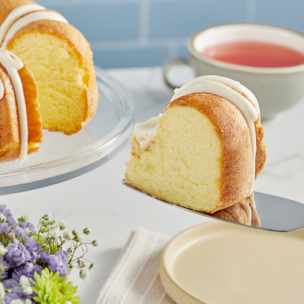 A slice of Pillsbury Creme Cake with white frosting on a plate.