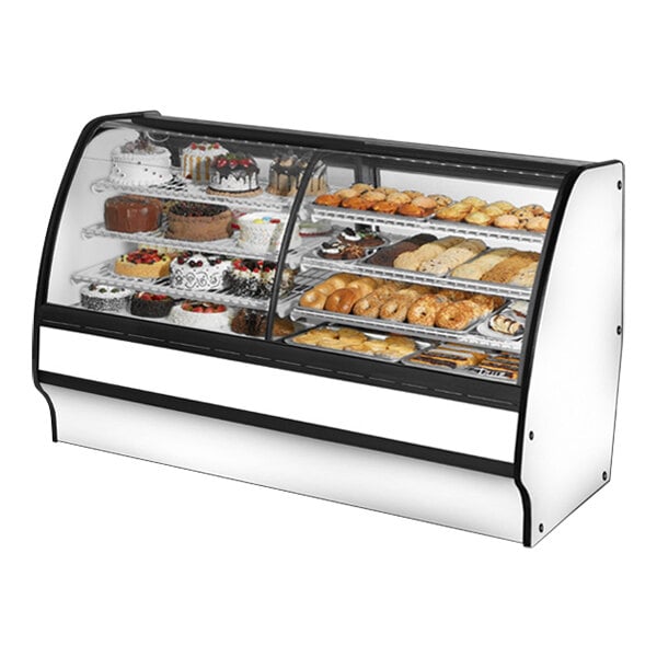 A True dual zone bakery display case with curved glass and a white interior filled with various pastries.