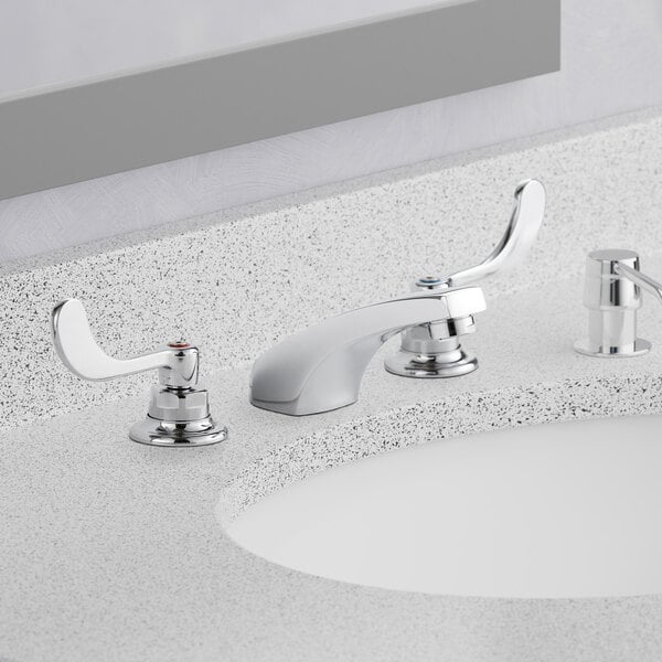 A white bathroom sink with an American Standard deck-mount faucet.