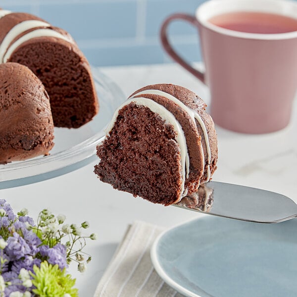 A piece of Pillsbury chocolate cake with white frosting on a plate.