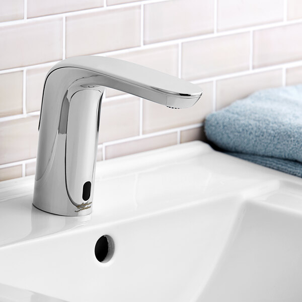 An American Standard chrome NextGen Selectronic lavatory faucet on a sink.