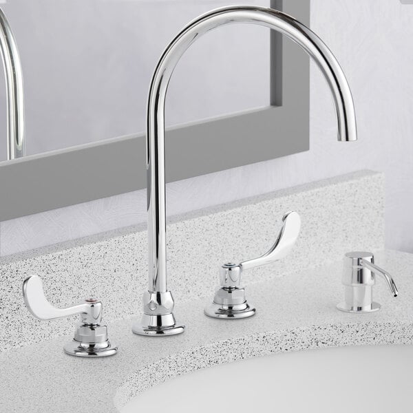 An American Standard deck-mount faucet with two spouts on a white surface.