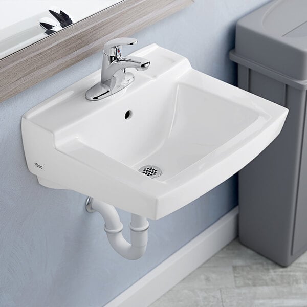 A close-up of a white American Standard Declyn wall-mount bathroom sink.