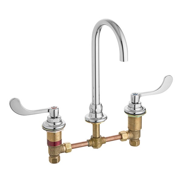An American Standard deck-mount faucet with two brass handles.