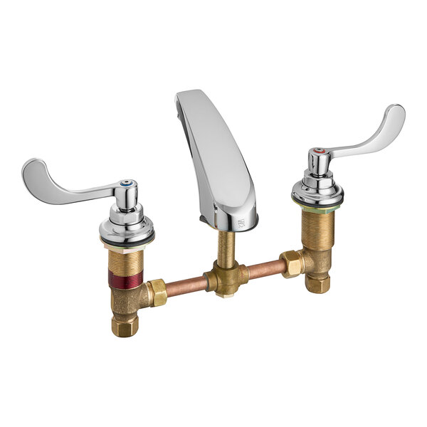 An American Standard deck-mount faucet with brass spout and wrist blade handles.
