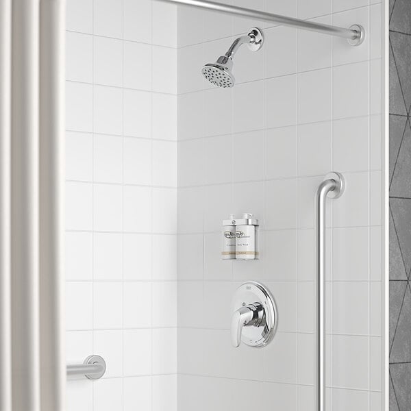 A bathroom with a white shower featuring an American Standard Colony Pro valve and shower trim kit with both a shower head and hand held shower head.