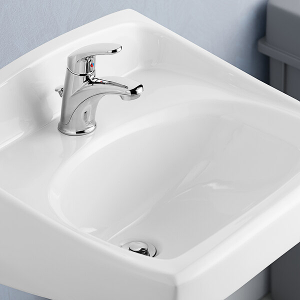A white American Standard Colony Pro deck-mount lavatory sink with single lever control faucet.