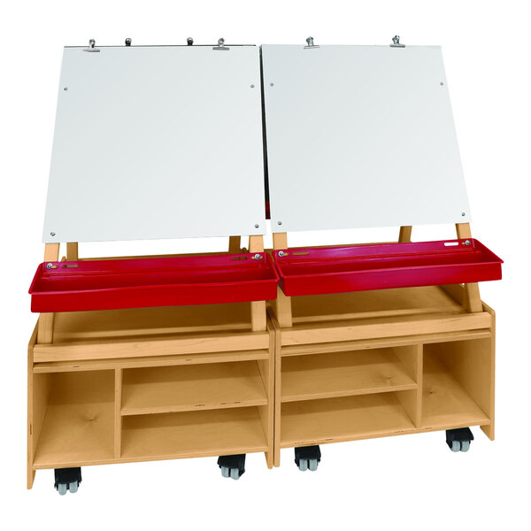 A Whitney Brothers white wood art center with red trays and easels.