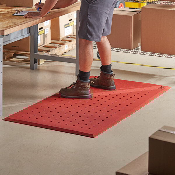 A man standing on a red Lavex anti-fatigue floor mat.