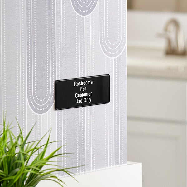 A Lavex Restrooms sign that reads "For Customer Use Only" in black and white text on a wall.