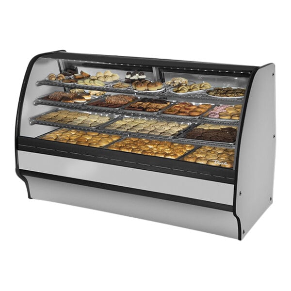 A True curved glass stainless steel dry bakery display case filled with different types of pastries.