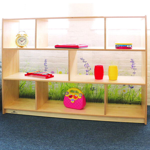 A Whitney Brothers wooden cabinet with a colorful flower pattern on a shelf.