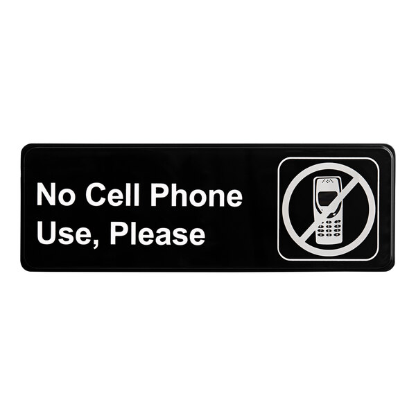 A black and white rectangular sign that says "No Cell Phone Use, Please"