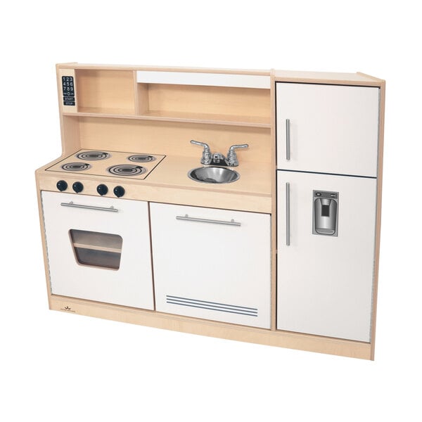 A white and wood Whitney Brothers toy kitchen with a sink.