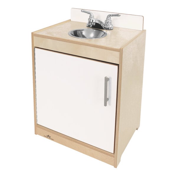 A Whitney Brothers white sink and cabinet on a counter.