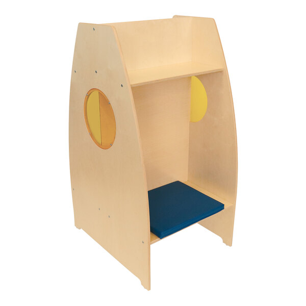 A Whitney Brothers wooden reading pod with a blue cushion on one side.