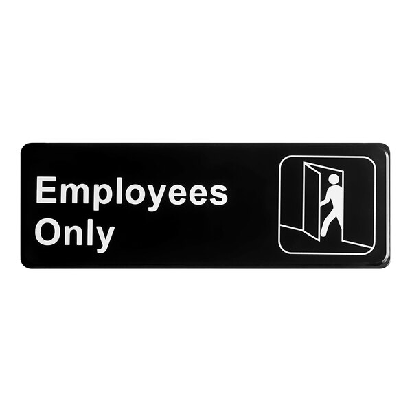 A black sign with white text that says "Employees Only"