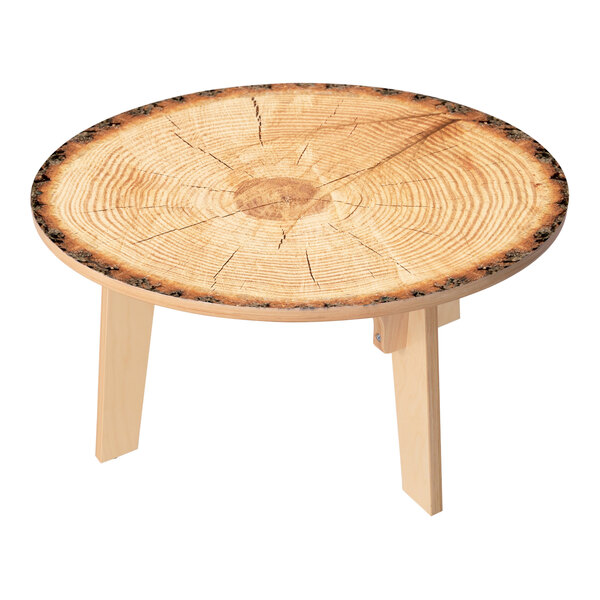 A Whitney Brothers round wooden table with a tree stump center.