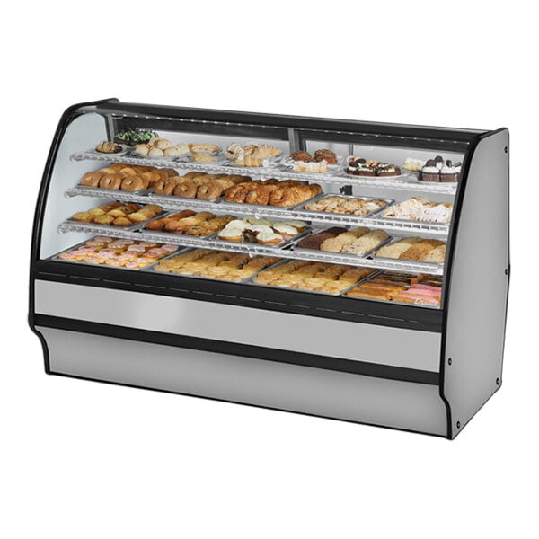 A True curved glass dry bakery display case with pastries.