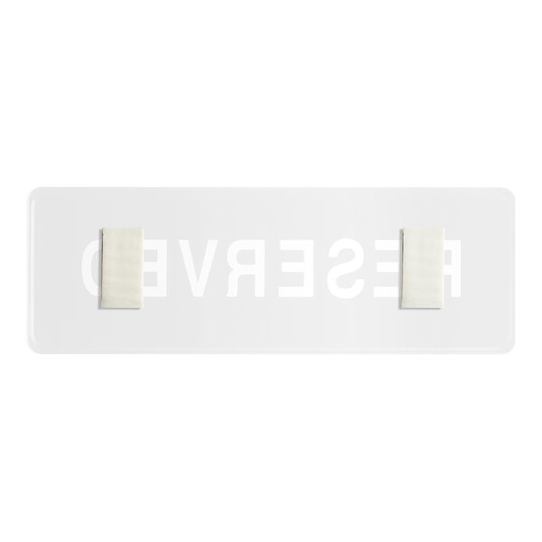A white rectangular sign with black text reading "Reserved" and a black border.