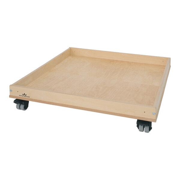 A Whitney Brothers wooden tray with wheels.