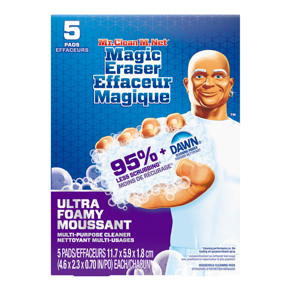 A hand holding a Mr. Clean Magic Eraser with Dawn over a counter.