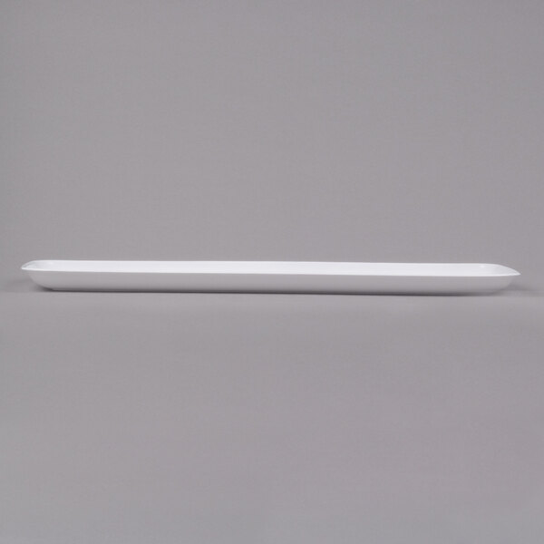 A white rectangular Sabert Polypropylene platter with a long handle.