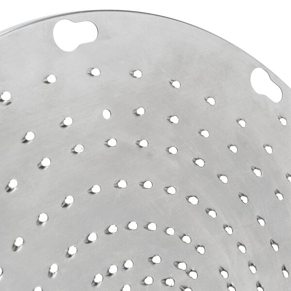 A stainless steel circular shredder plate with holes.