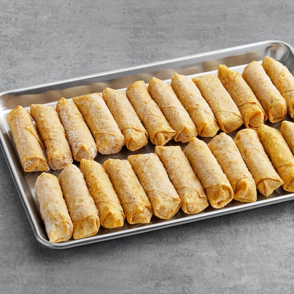 The Gourmet Egg Roll Co. Sausage, Egg, and Cheese Egg Rolls on a tray on a gray surface.