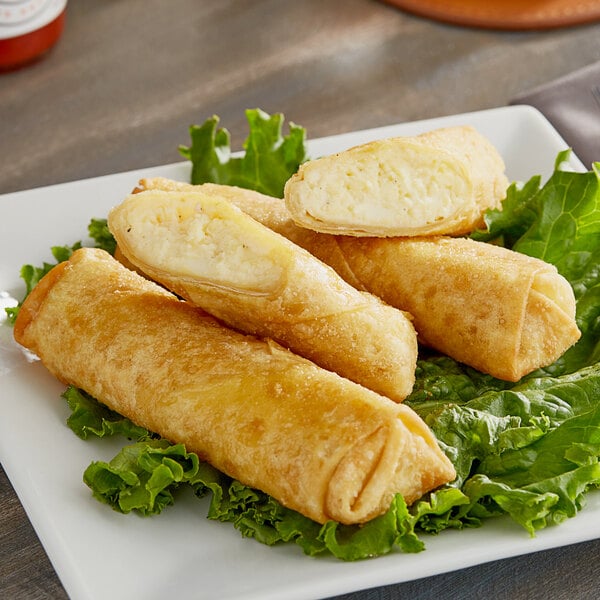 A white plate with fried Gourmet Egg Roll Co. Egg and Cheese Egg Rolls.