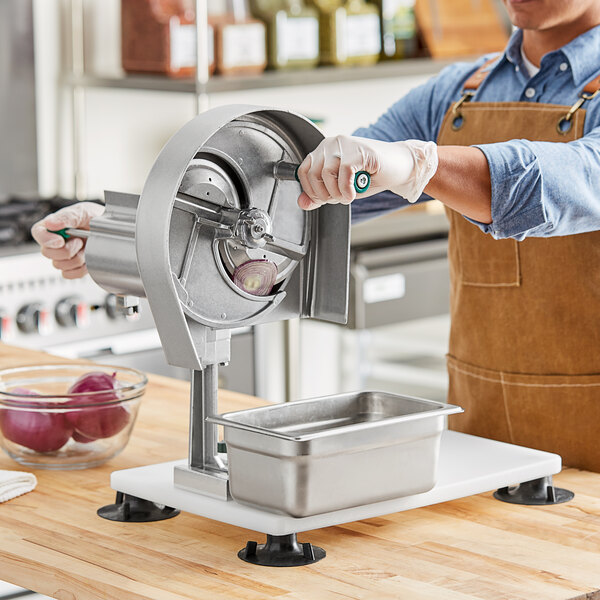 A man using a Garde XL fruit and vegetable rotary slicer on a counter.