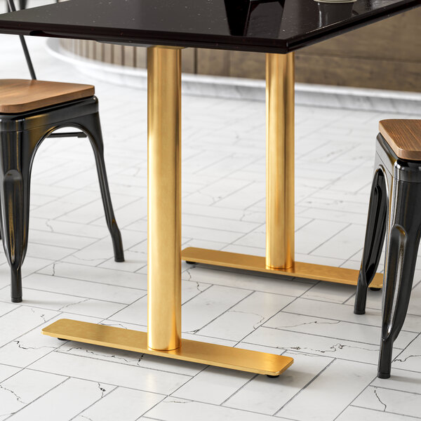 A black table with a gold Art Marble Furniture end table base.