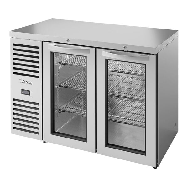 A stainless steel True back bar refrigerator with glass doors.