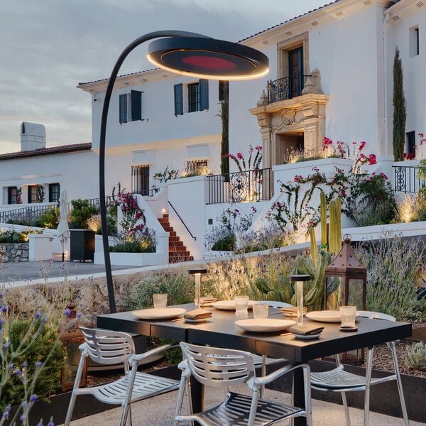 A Bromic Heating outdoor patio heater on a table outside a building.