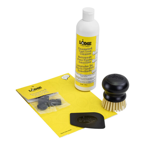 A Lodge enameled cast iron and stoneware cleaning kit with a brush and sponge.