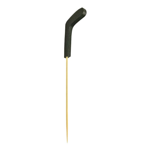 A bamboo cocktail pick with a black hockey stick-shaped top.