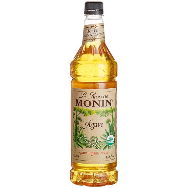A Monin bottle of organic agave nectar syrup with a label.