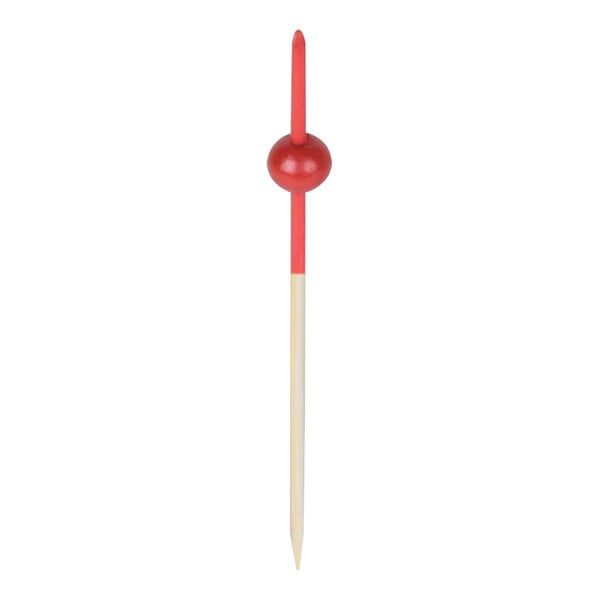 A wooden bamboo food pick with a red beaded end.