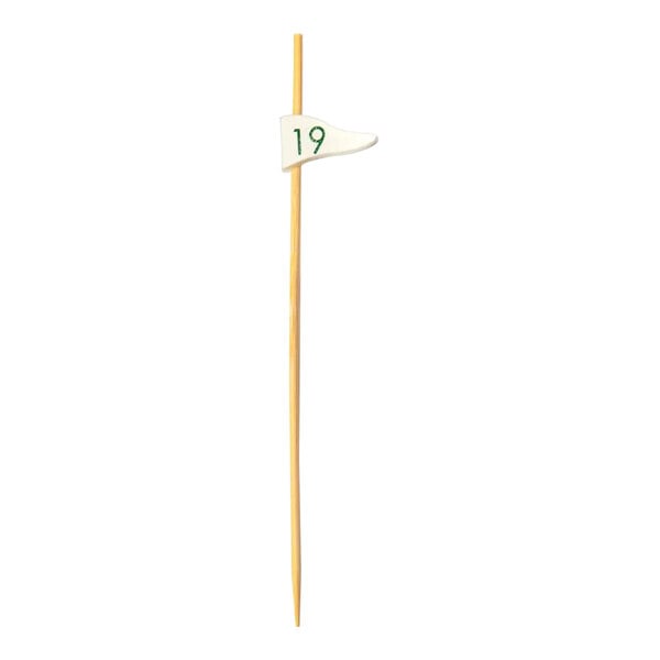 A bamboo food pick with a white flag and green numbers on it.