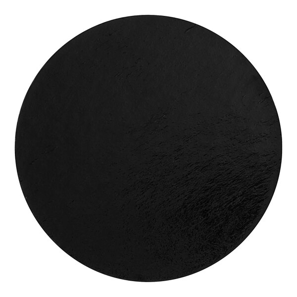 A black and gold reversible round dessert board.