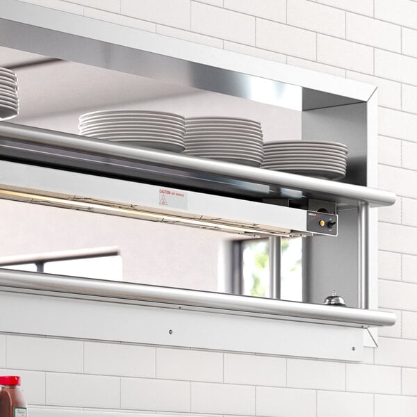 A ServIt double strip warmer on a shelf in a commercial kitchen.