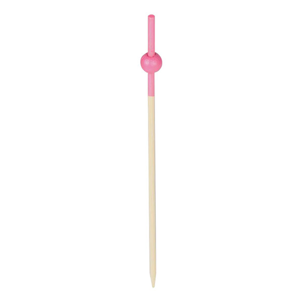 A pink wooden food and cocktail pick with beaded handle.